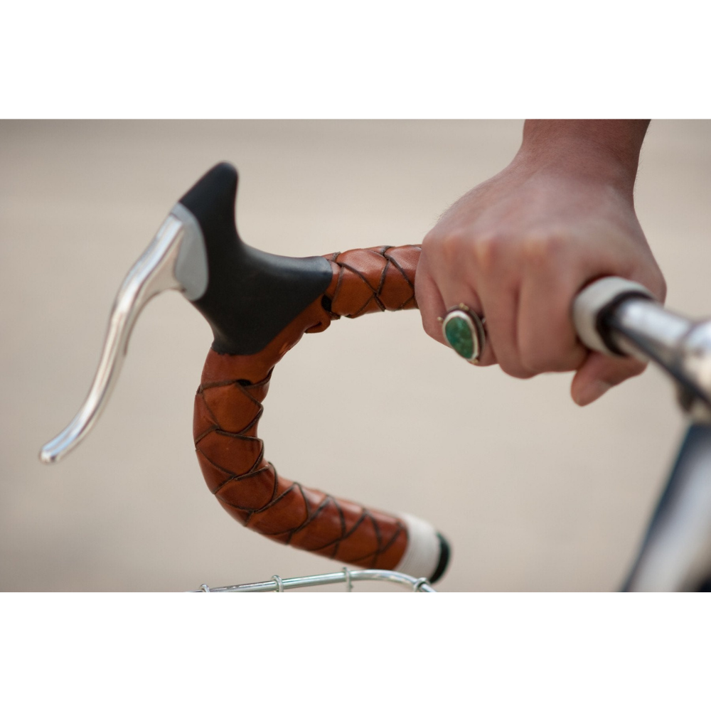 Another angle showing a close-up of the honey braided leather with white waxed thread whip-tied at the top of the drop bar near the stem. 