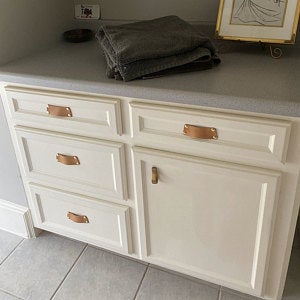 Customer photo showing a white kitchen remodel with natural leather Morrison bin pulls on the drawers and Hawthornes on the cabinet doors. 