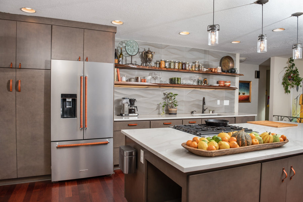 beautifully photographed clean kitchen with olive dark green cabinetry, honey leather handles, and honey wrap on fridge appliance handles